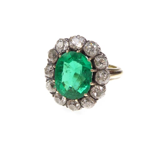 Antique emerald and diamond cluster ring, claw set with a cushion cut emerald